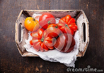 Ripe fresh colorful tomatoes in wooden box