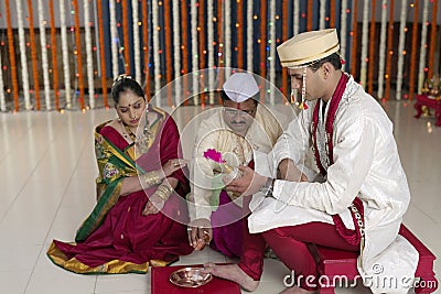 Rituals in Indian Hindu wedding showing respect and blessings.