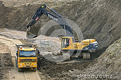 Road construction with truck and excavator