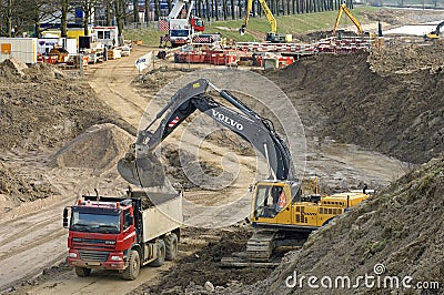 Road construction with truck and excavator