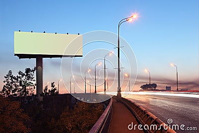 Road with lights and large blank billboard