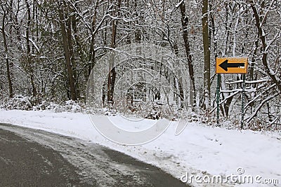 Road with sign turn left at winter time