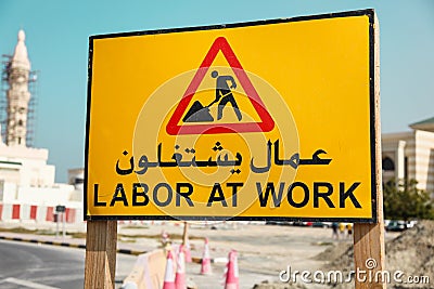 Road Warning Sign - Labor at Work writen on a arab and english language