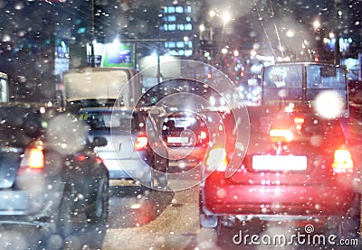 Road in winter night, traffic jams, snow city