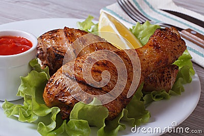 Roasted chicken legs with salad, lemon and ketchup