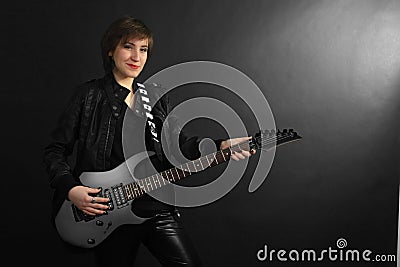 Rock girl in leather outfit with electric guitar