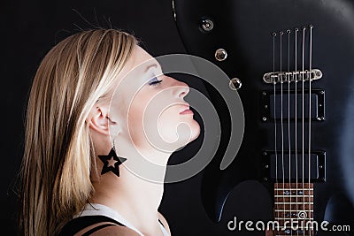 Rock music. Girl musician guitarist with electric