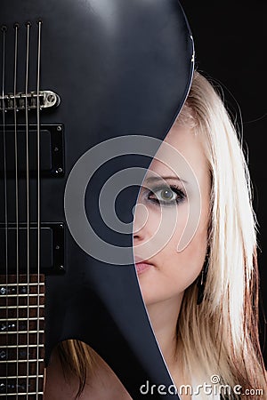 Rock music. Girl musician guitarist with electric guitar