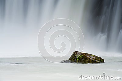 Rock with a waterfall on a background, Iceland