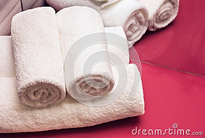 Rolled white towels in bathroom