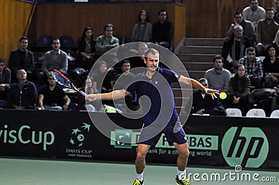 Romanian tennis player Marius Copil in action