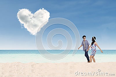 Romantic couple walking on the beach