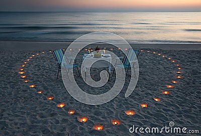 Romantic dinner on the sea beach with candle heart