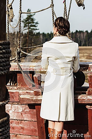 Romantic fashion portrait of a beautiful woman on a ship