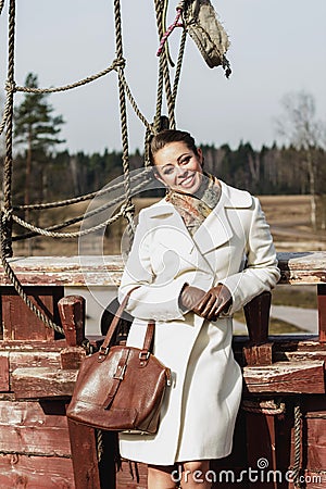 Romantic fashion portrait of a beautiful woman on a ship