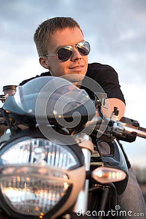 Romantic portrait handsome biker man in sunglasses