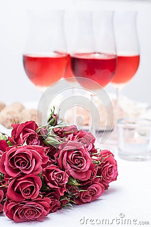 Roses and several glasses of rose wine