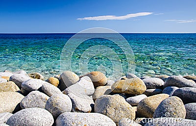 Round stones and clear sea