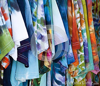 Row of colorful patterned T-shirts hanging up