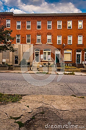 Row houses and cracked sidewalk in Baltimore, Maryland.