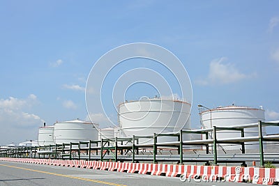 Row of large white tanks for petrol and oil