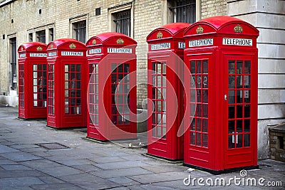 Row of old style UK red phone boxes