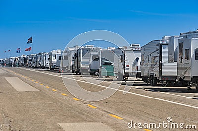 Row of recreational vehicles parked on road