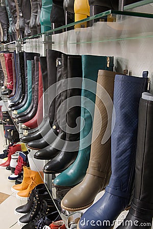 Rows of beautiful female boots on store shelves.