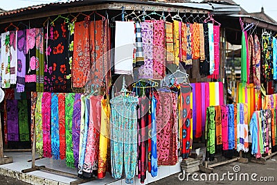 Rows of colourful silk scarfs hanging at a market stall in Indon