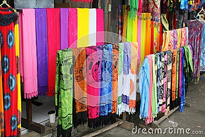 Rows of colourful silk scarfs hanging at a market stall in Indon