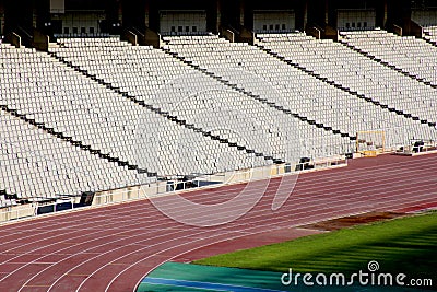 Rows of seats in stadium and track and field lane