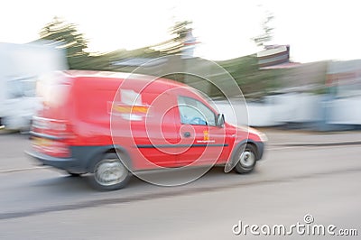 Royal Mail van blurred and in motion.