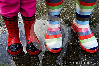 Rubber boots in a rain puddle