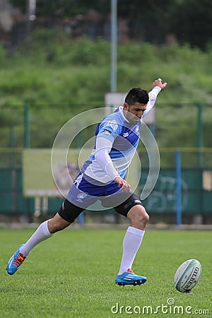 Rugby player kicking the ball