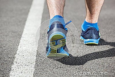 Runner feet running on stadium