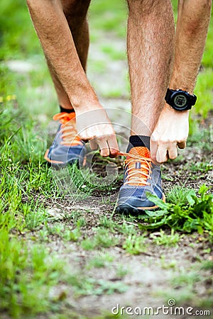 Runner tying sports shoe