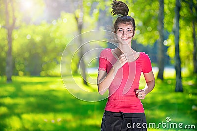 Runner - woman running outdoors in green park