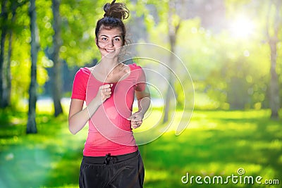 Runner - woman running outdoors in green park