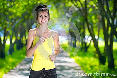 Runner - woman running outdoors in green park