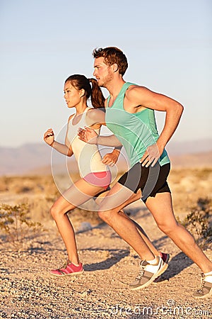 Runners couple running in trail run outside