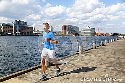 Running man jogging in modern city