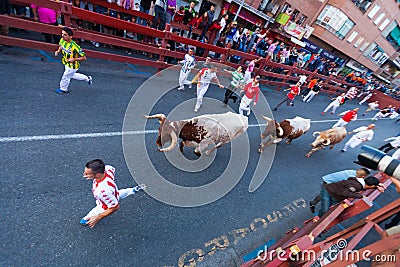 Running people and bulls