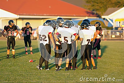 A rural Oregon high school foot ball team in a huddle