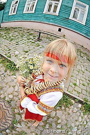 Russian girl in national costume with bagels and flowers