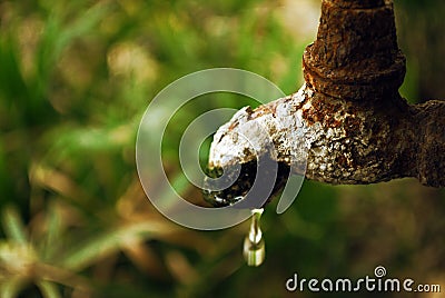 Rusted tap with water drop