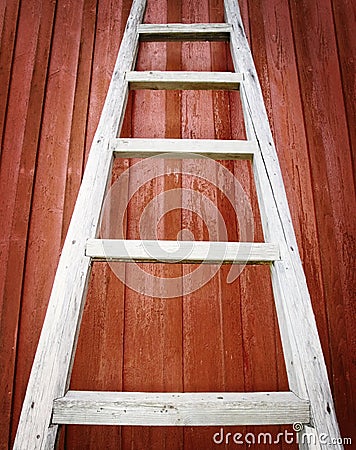 Rustic wooden ladder on red background