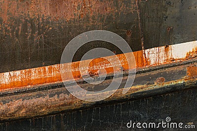 Rusting hull and peeling paint on an old deep sea fishing trawle