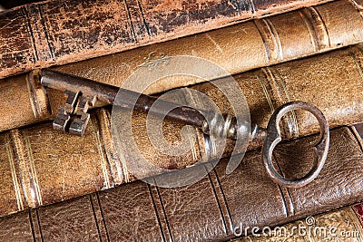 Rusty key on old books