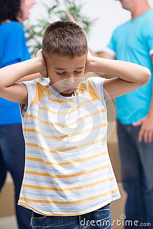 Sad boy in new home while parents quarreling