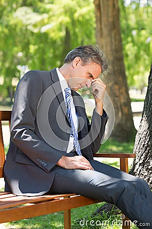 Sad businessman in park